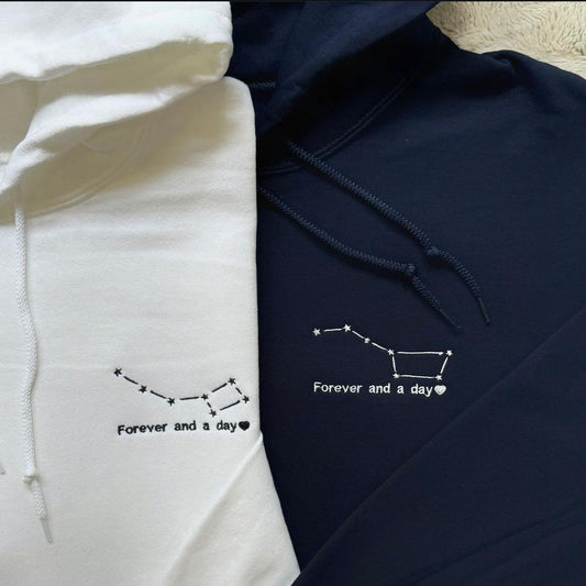 Matching couple hoodies with embroidered constellation design and the phrase “Forever and a day” on the front.