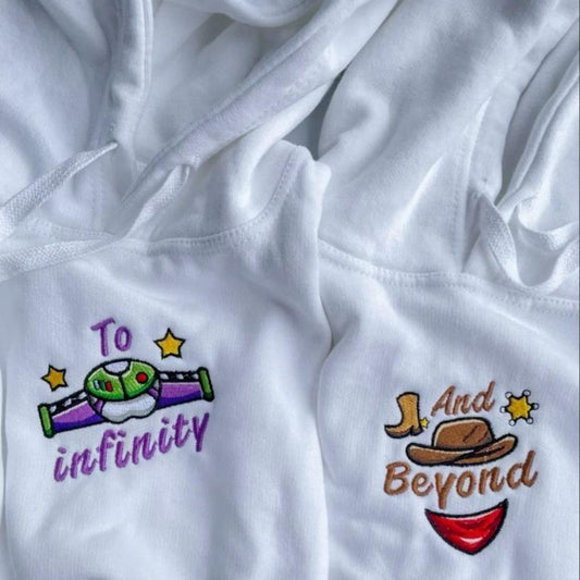 Matching couple hoodies with embroidered “To Infinity” and “And Beyond” text featuring space and cowboy-themed designs.