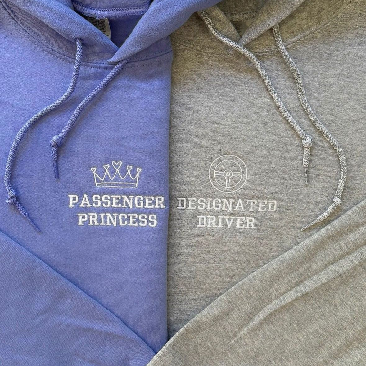 Matching couple hoodies with embroidered text – "Passenger Princess" with crown and "Designated Driver" with steering wheel icon.