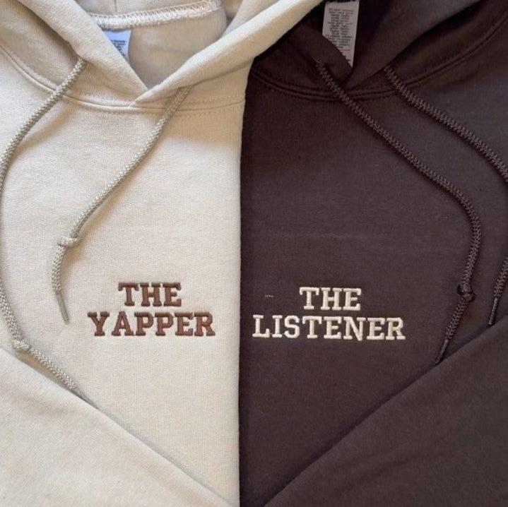 Matching couple hoodies with embroidered text on the front – “THE YAPPER” and “THE LISTENER.”